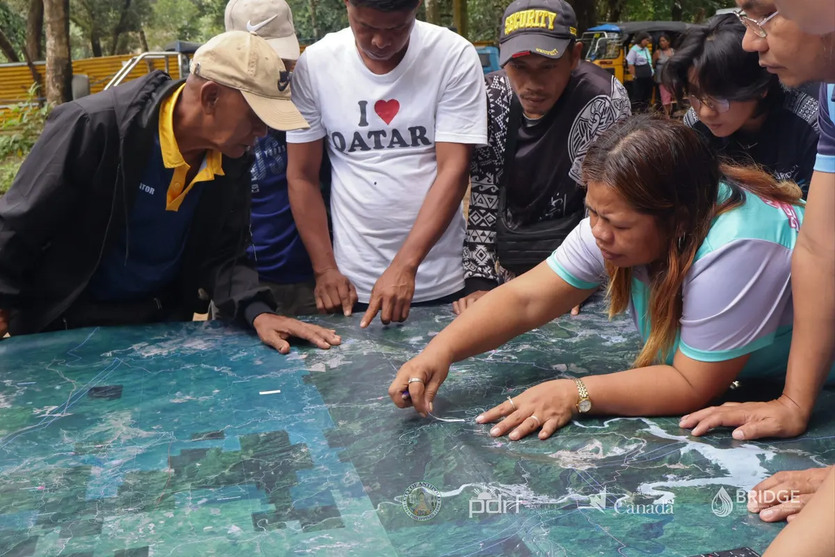Dumagat-Remontado community members identify locations together on a large map of their ancestral domain.